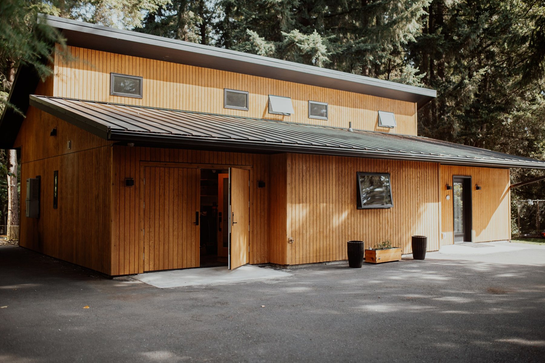 View along the cabin's cedar-clad front elevation from the driveway