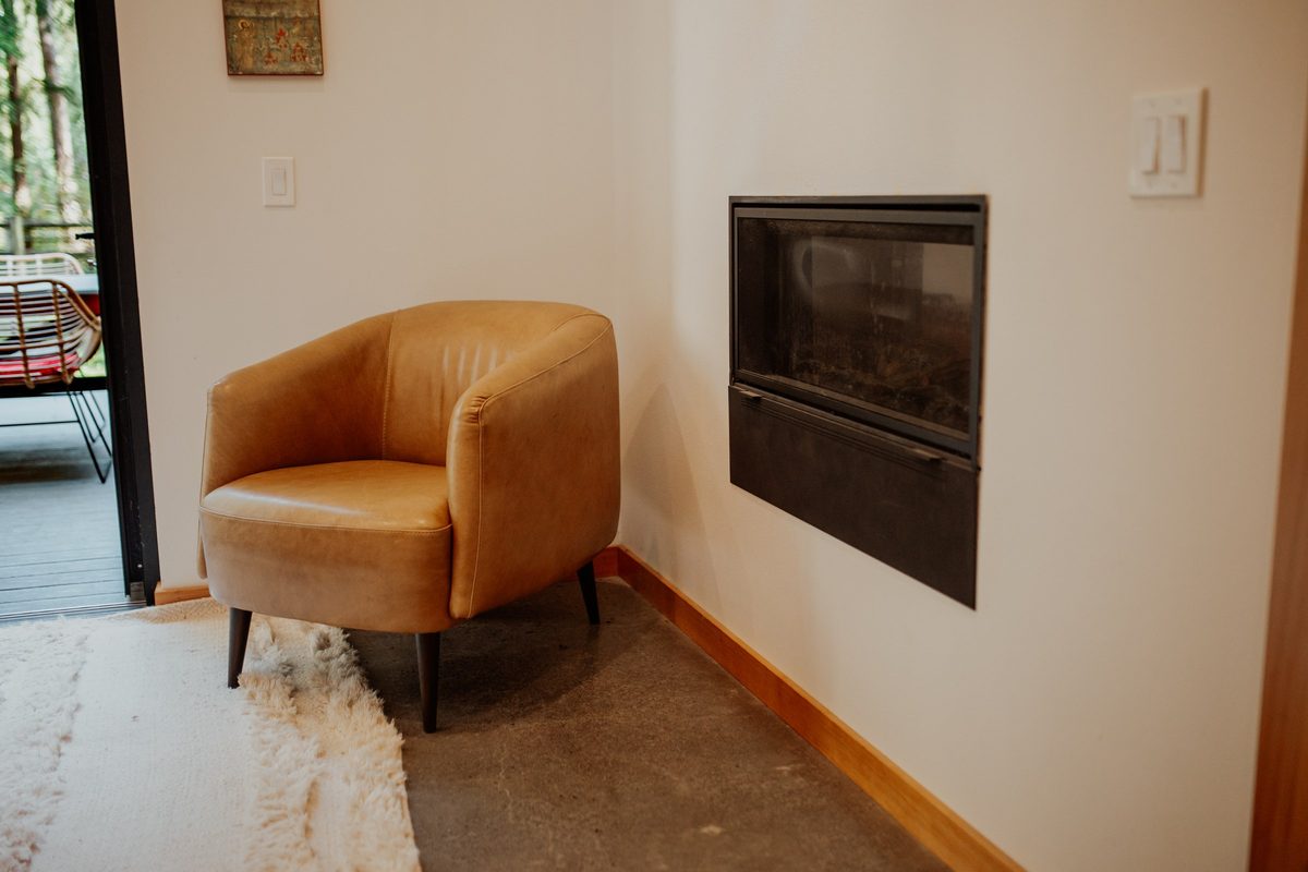 Reading chair beside the cabin's two-sided fireplace