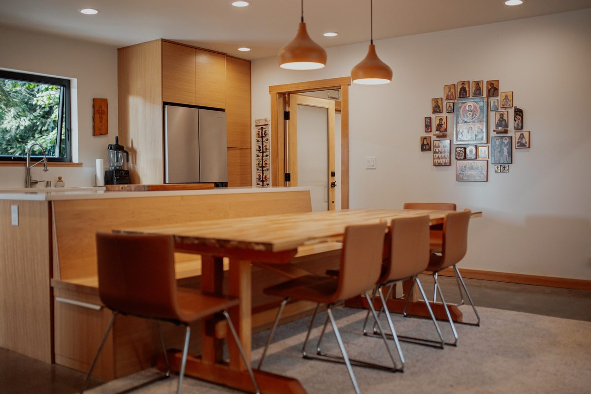Dining table and chairs with the cabin kitchen beyond