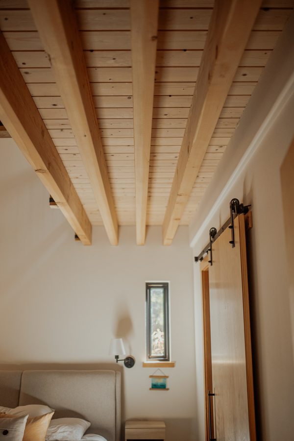 Exposed wood joists above the cabin bedroom